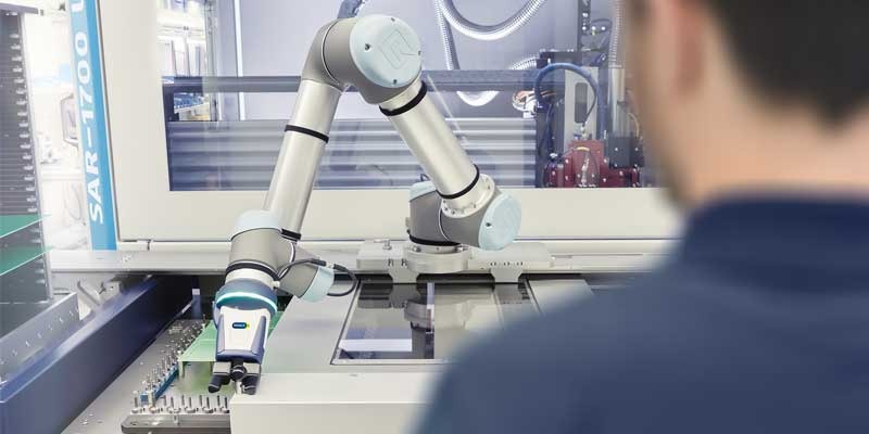 Humans and robots collaborate in electronics industry